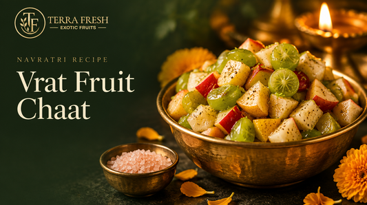 Vrat fruit chaat in a brass bowl with rock salt and a diya