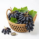Fresh Black Moon grapes in a bamboo basket