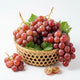 Fresh Red Globe grapes in a bamboo basket