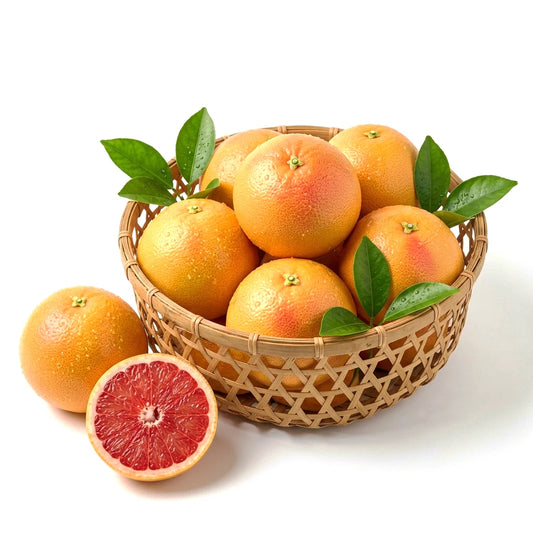 Fresh ruby red grapefruit in a bamboo basket with one cut in half showing pink citrus flesh